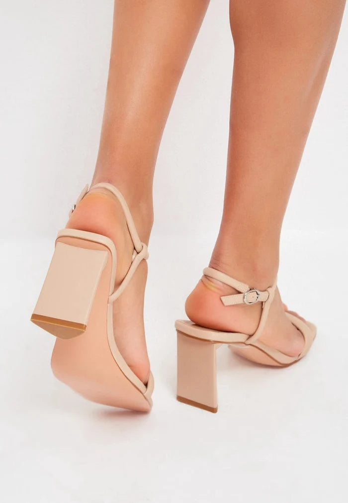 A pair of elegant beige heels, the epitome of high-end designer footwear for women's dress shoes, exuding elevated elegance and style.