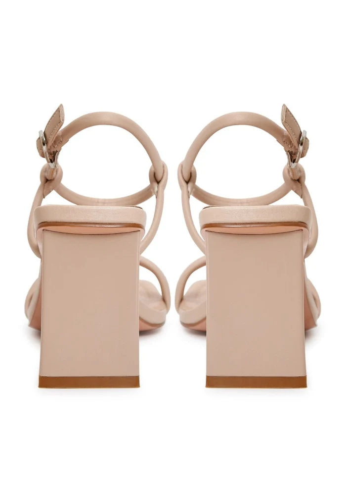 A pair of stylish beige heels, perfect for women's dress shoes, showcasing elevated elegance footwear from high-end designer collection.