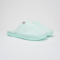 Angled view of Lido Essential slipper in aqua showcasing ribbed terry upper, low open-back silhouette, and cushioned foam sole on white background