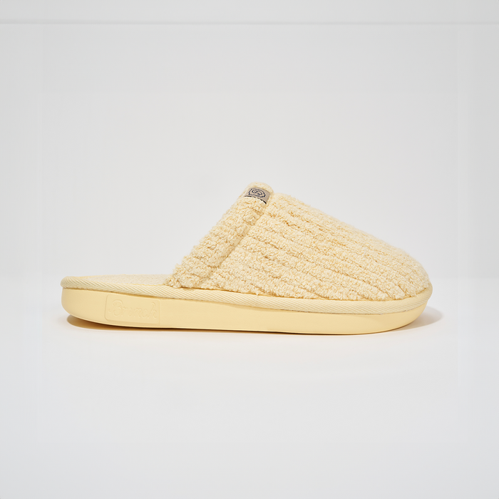 Side profile of Essential slipper in Limoncello ribbed terry showcasing ribbed texture and EVA outsole on white background