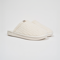 Angled side view of The Essential slipper in Panna ribbed terry showing plush ribbed upper and EVA outsole on white background