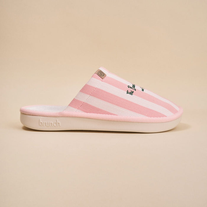 Side view of pink striped Essential slipper with 'Beverly Hills Hotel' embroidery on upper, white sole on beige background