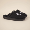 Three-quarter view of black Diet Coke x Brunch shearling slippers with faux-shearling lining, embroidered logo, and black sole