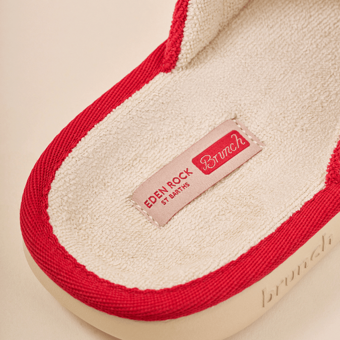 Close up of Eden Rock slipper interior showing beige terry insole, red piped trim and stitched Eden Rock St Barths label