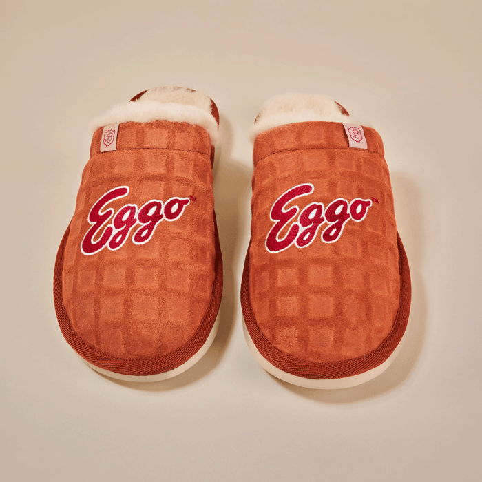 Top view of Essential Eggo slippers in syrup brown showing waffle-embossed suede upper, embroidered Eggo logo and cream shearling lining