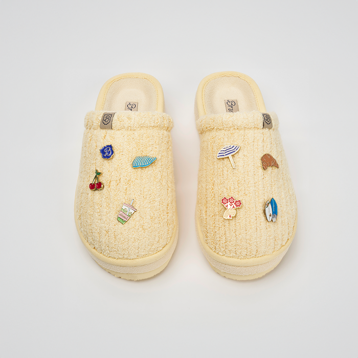 Top-down view of Essential XXL Limoncello ribbed terry slippers with plush ribbed texture and enamel charms on white
