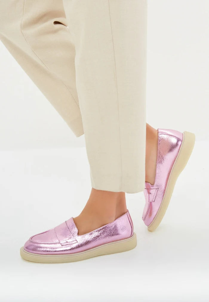 A stylish pair of metallic pink women's loafers with a flat sole, perfect for fashionable footwear enthusiasts.