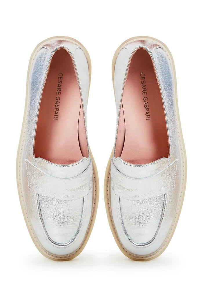 A stylish pair of women's slip-on flat sole silver loafers, perfect for any look.