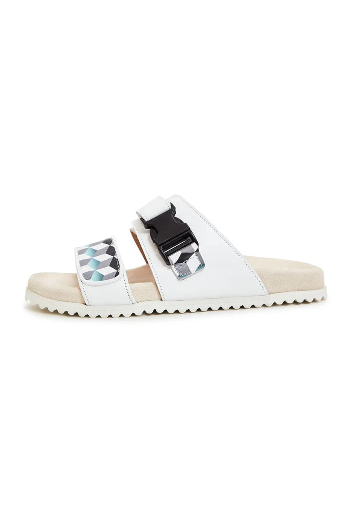 A pair of white Meredith mules, flat sole women's footwear perfect for summer days.