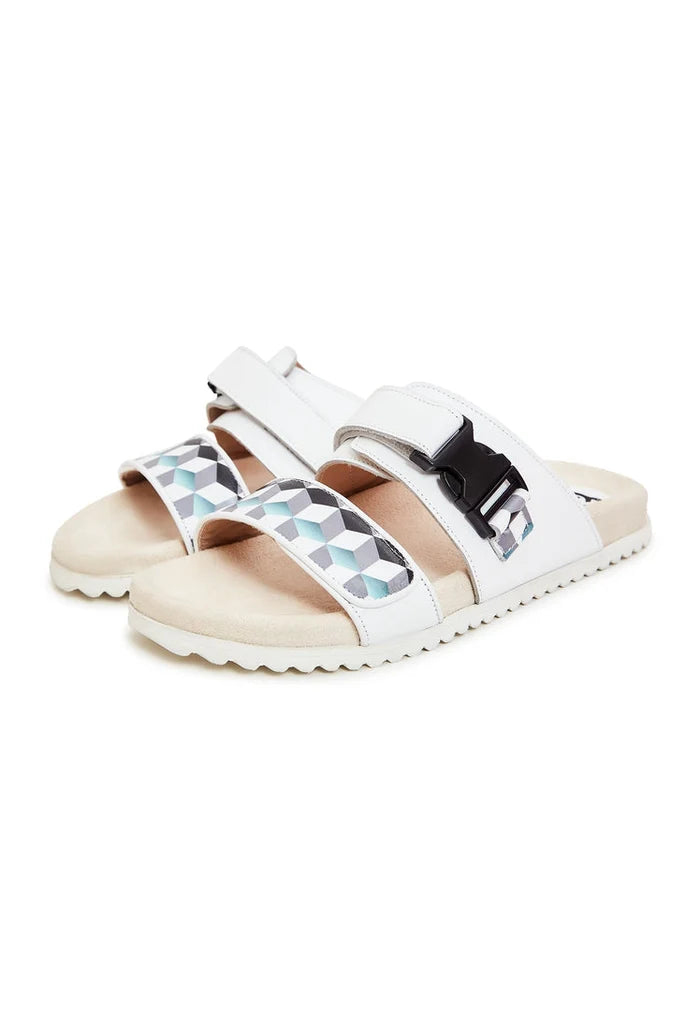A stylish pair of white Meredith mules with flat soles, perfect for women's summer footwear.