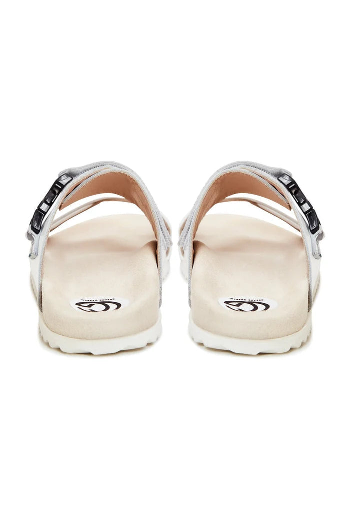 A stylish pair of white Meredith mules with a flat sole for women's footwear, perfect for summer sandals.