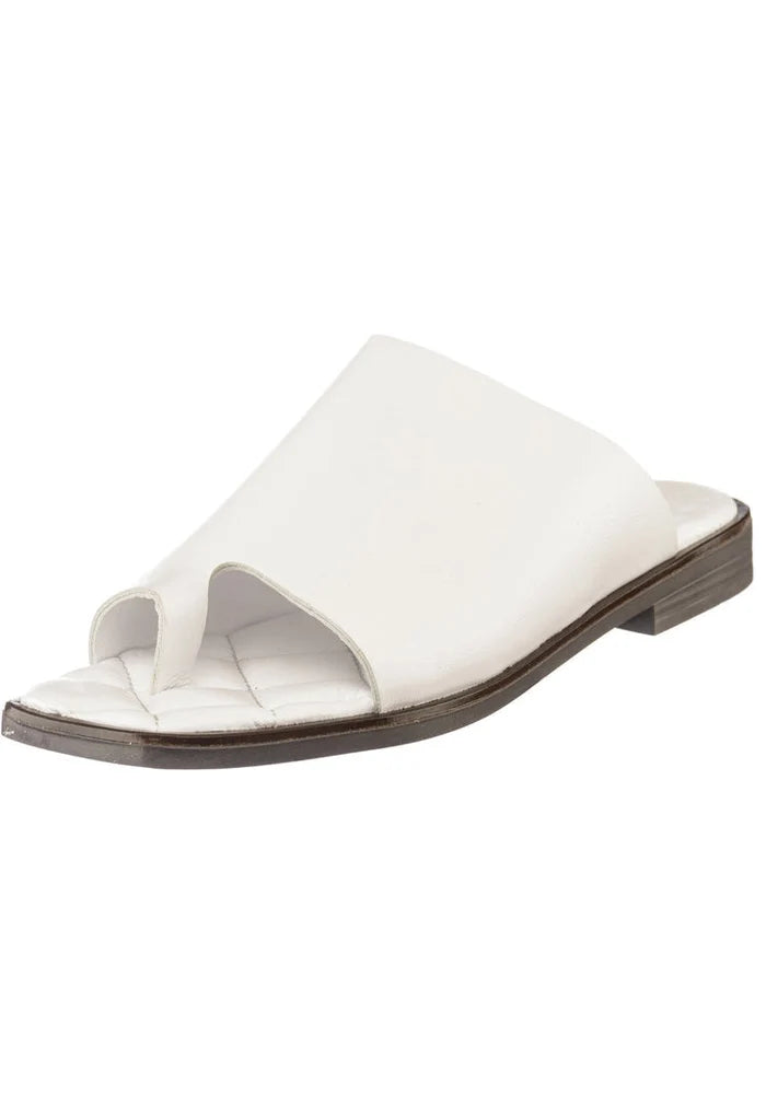 A pair of comfortable minimalist flat sole one toe loop sandals in a neutral color.