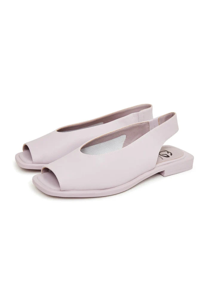 A pair of stylish flat sole violet women's sandals, perfect for summer and beach wear.