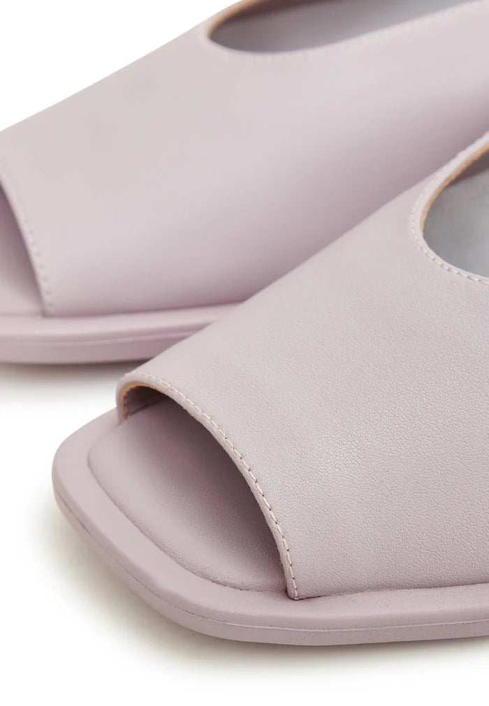 A pair of stylish women's flat sole violet sandals, perfect for summer and beach wear.