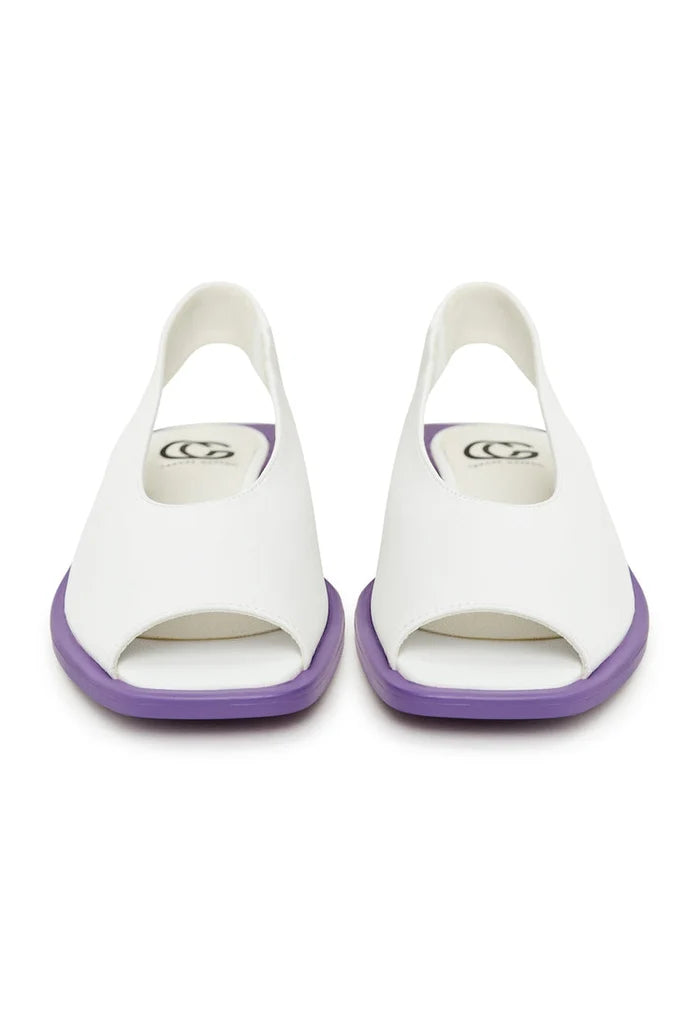 A pair of stylish white women's flat sole sandals, perfect for summer and casual wear.