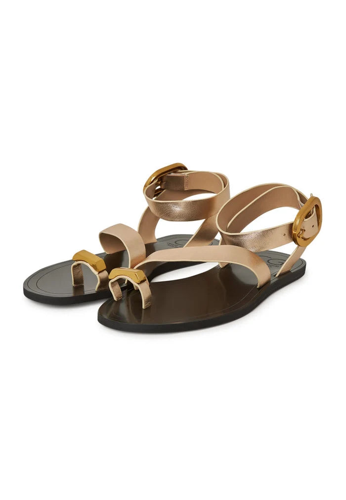 A pair of women's Paula flat sole gold sandals, perfect for a casual and comfy look.