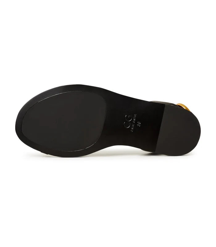 A pair of stylish Paula flat sole gold sandals for women, perfect for a casual and chic look.