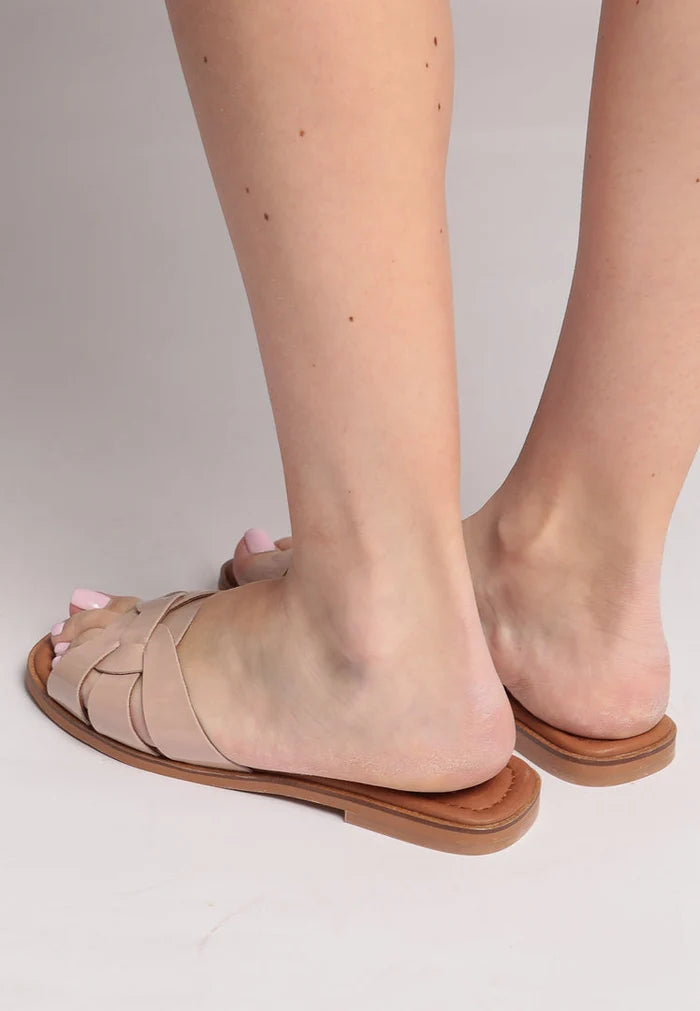 A pair of trendy beige slides with a gloss weave design, ideal for stylish summer footwear.