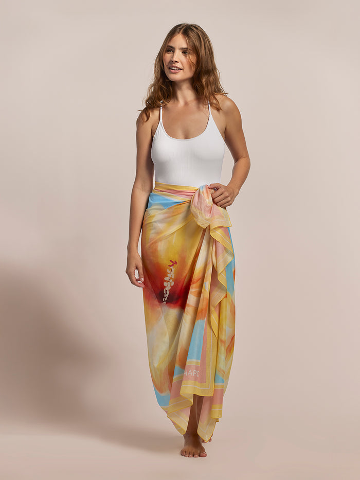 White tank top and red hibiscus-print pareo skirt, full length, plain background.