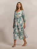 Blue-green patterned Hau Mae caftan dress, full front view with model’s hair loose.