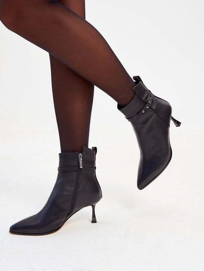 A pair of stylish women's high heeled leather ankle boots, also known as leather booties, for a fashionable and trendy look.