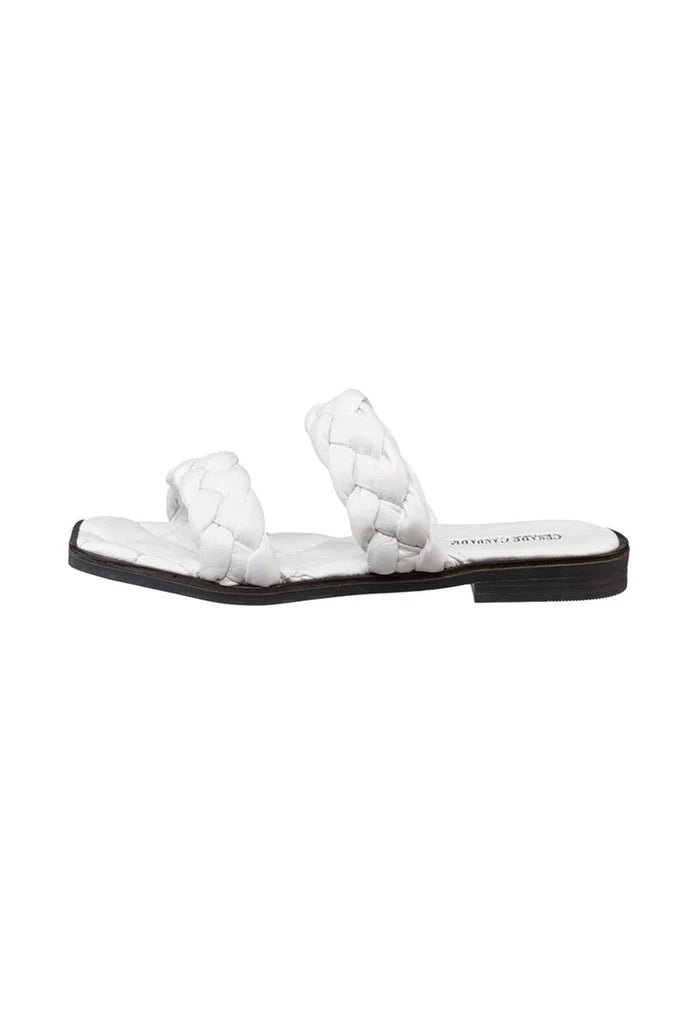 A pair of high quality soft leather white flat sole sandals, perfect for all-day comfort and style.