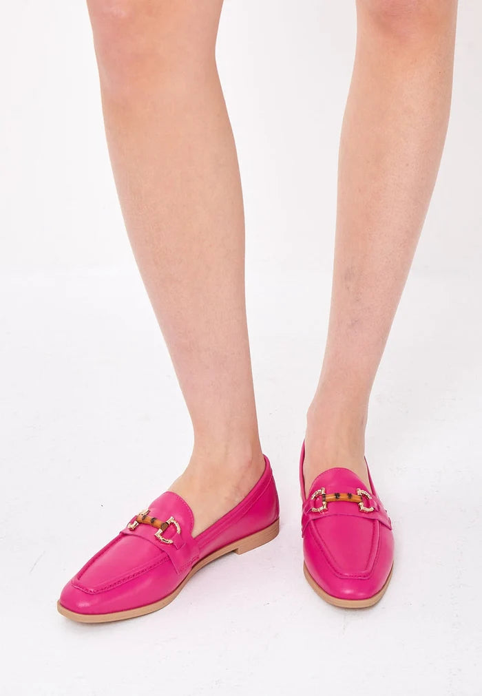 A pair of high-quality fuchsia leather loafers, a premium luxury footwear option.