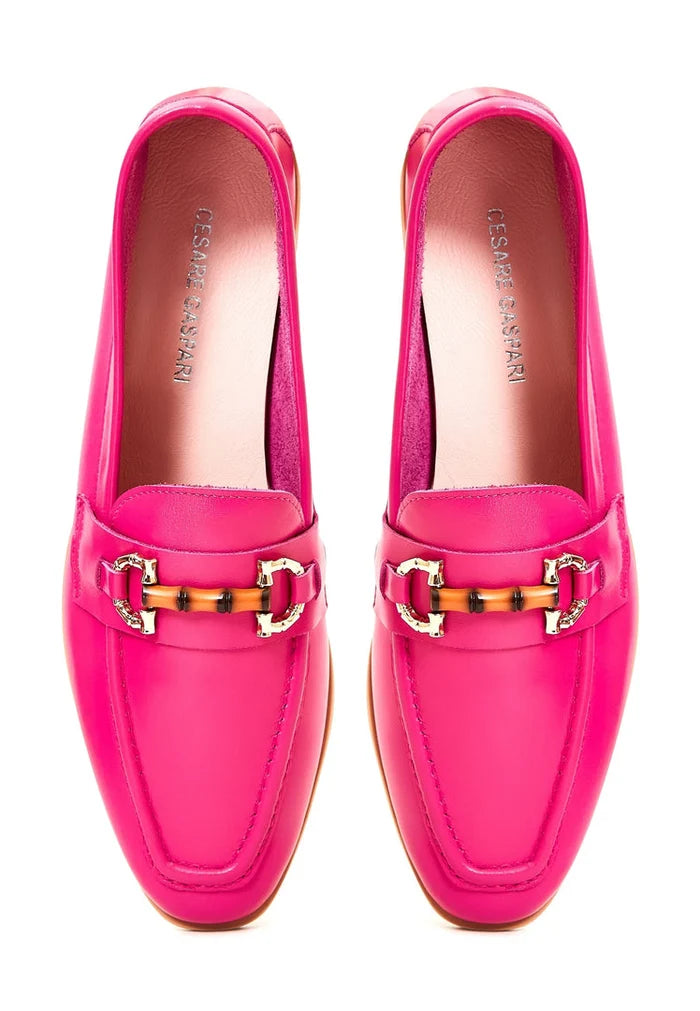A stylish pair of fuchsia leather loafers, crafted from premium, high-quality leather - the epitome of luxury footwear.