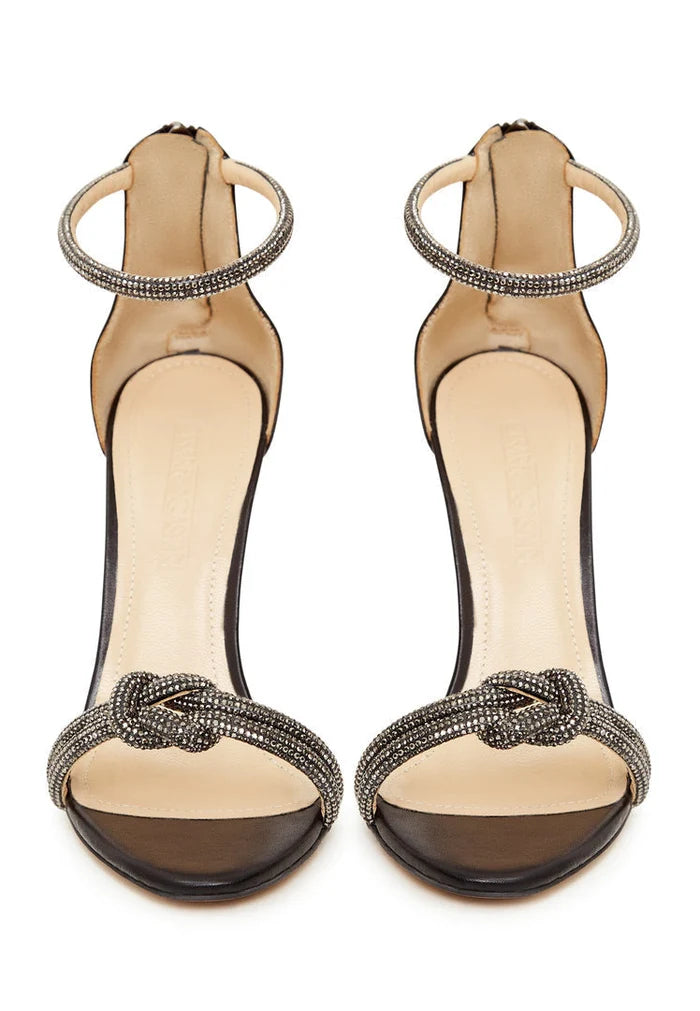 A stylish pair of black high heel sandals with jewel embellishments, perfect for any woman looking for elegant and fashionable footwear.