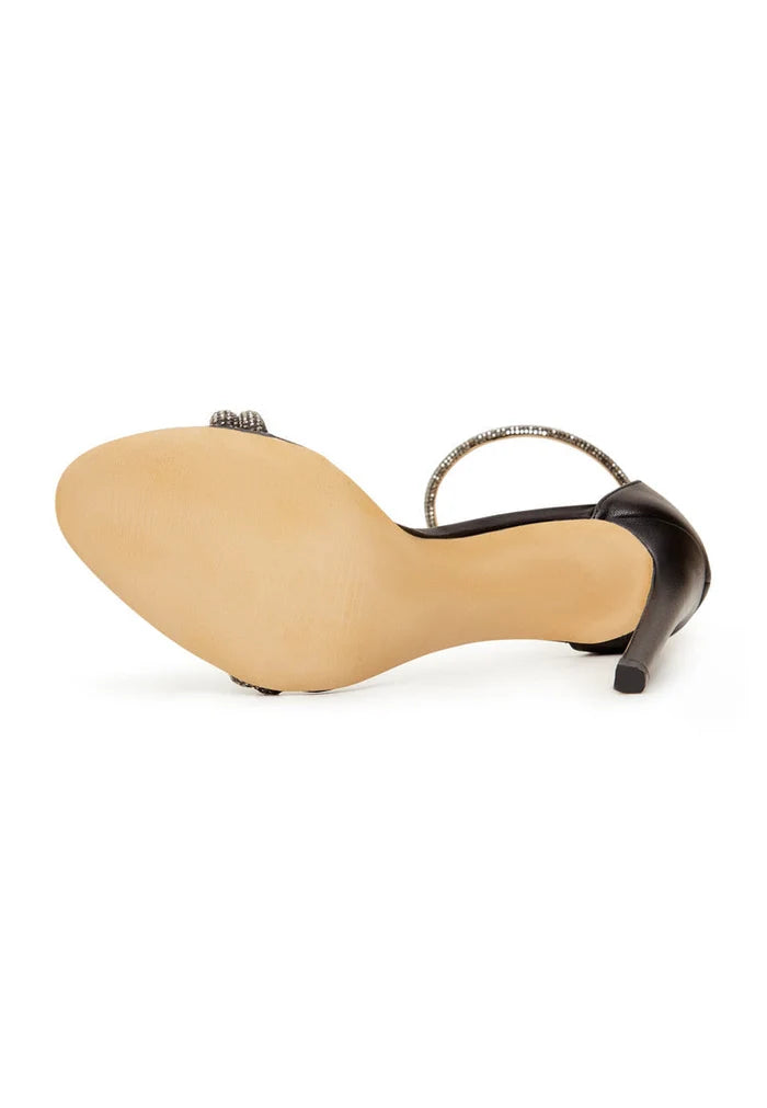 A pair of elegant black high heel sandals with jewel embellishments for women who love fashion.