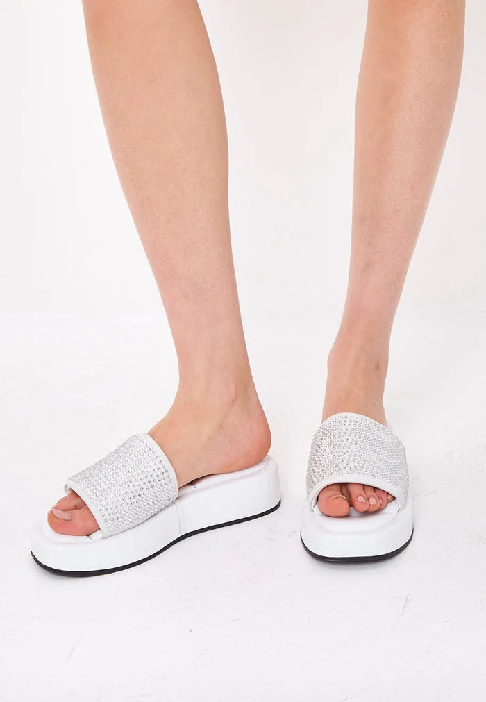 A pair of elegant white platform mule sandals with jewel embellishments, perfect for women looking for high heel platform shoes as fashionable footwear.