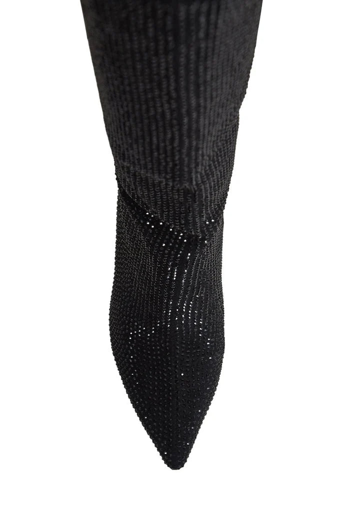 A pair of fashionable knee-high women's stiletto boots in black, featuring a jewel detail and identified as the Mili Black Boots.