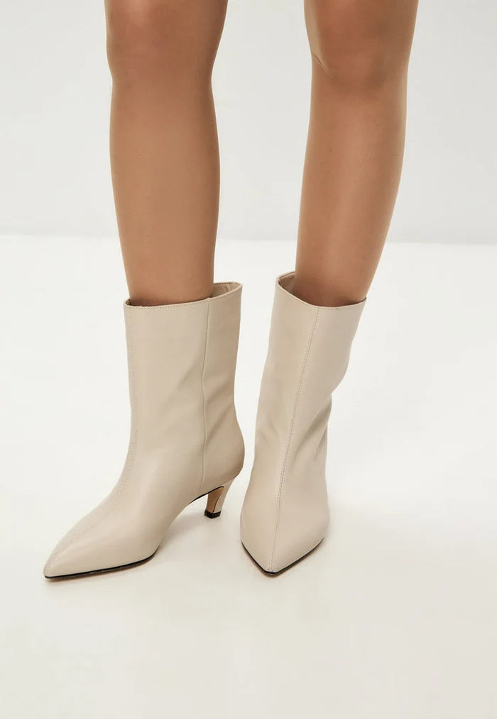 A trendy pair of white kitten heel ankle boots, perfect for fashion-forward women looking for stylish dolly ankle boots.