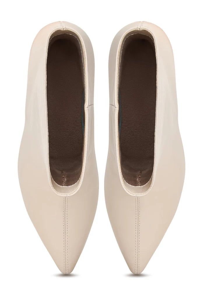 A pair of trendy white kitten heel ankle boots, perfect for women looking for stylish Dolly ankle boots.