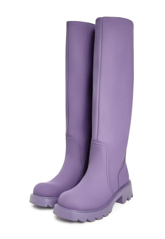 A fashionable pair of knee-high chunky sole lilac boots, the perfect trendy footwear for women's autumn fashion.
