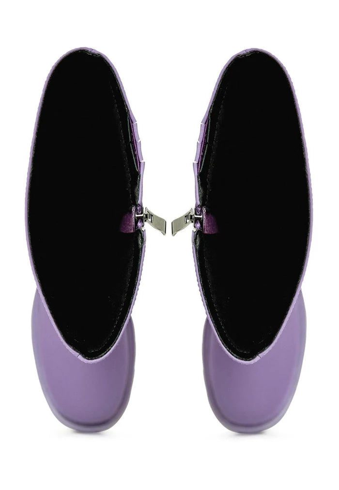 A stylish pair of chunky sole knee-high lilac boots, perfect for the fashion-forward woman looking for trendy footwear.