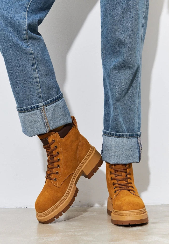 A pair of stylish lace-up ankle boots in trendy leather design for women.