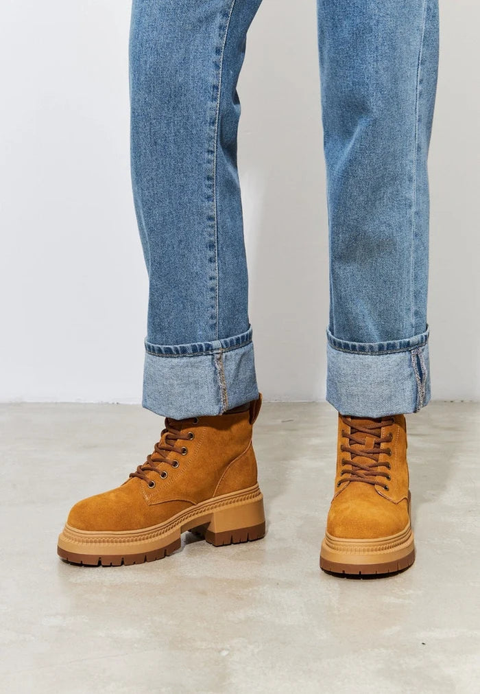 A stylish pair of women's lace-up ankle boots in trendy leather design, perfect for any outfit.