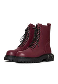 A pair of stylish lace-up combat boots with a chunky sole in a trendy bordeaux color, perfect for fashion-forward women's footwear trends.