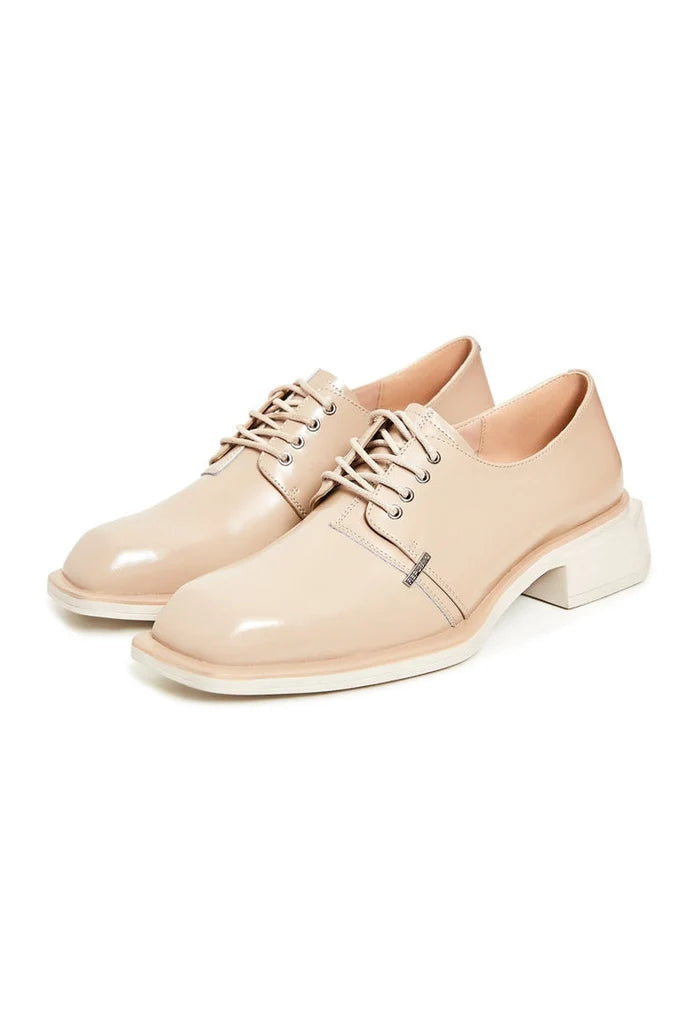A stylish pair of beige leather lace-up loafers for men.