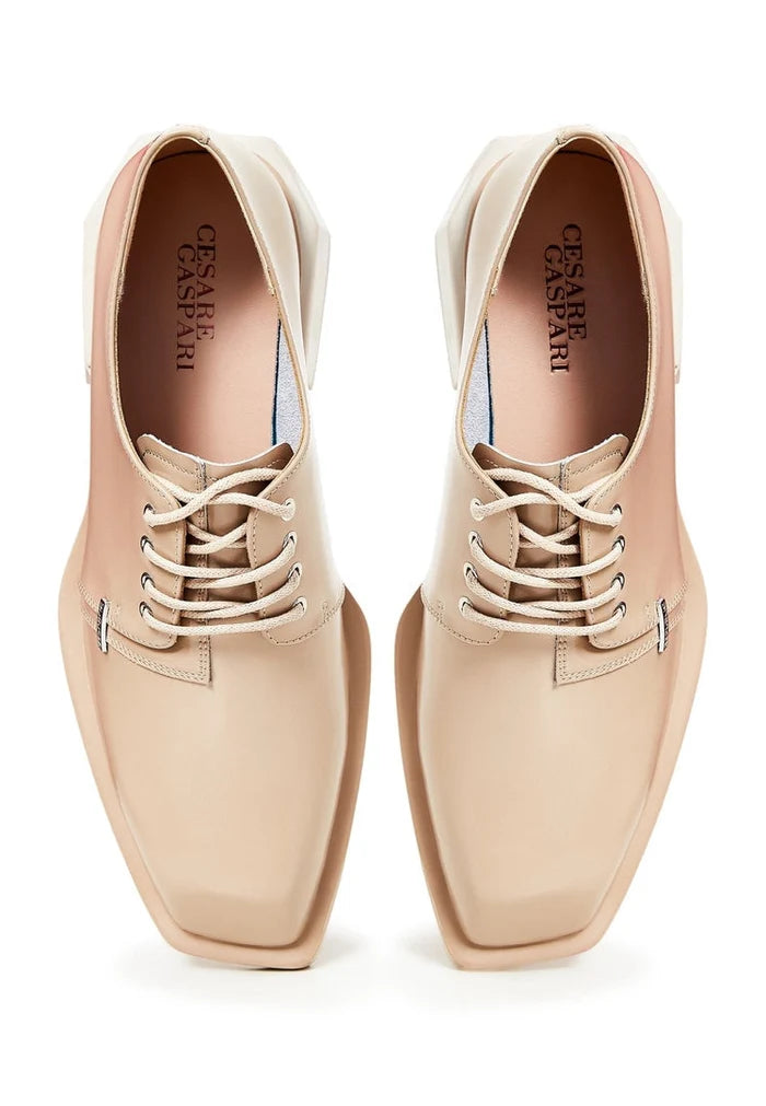 A stylish pair of beige lace-up loafers for men crafted from leather.