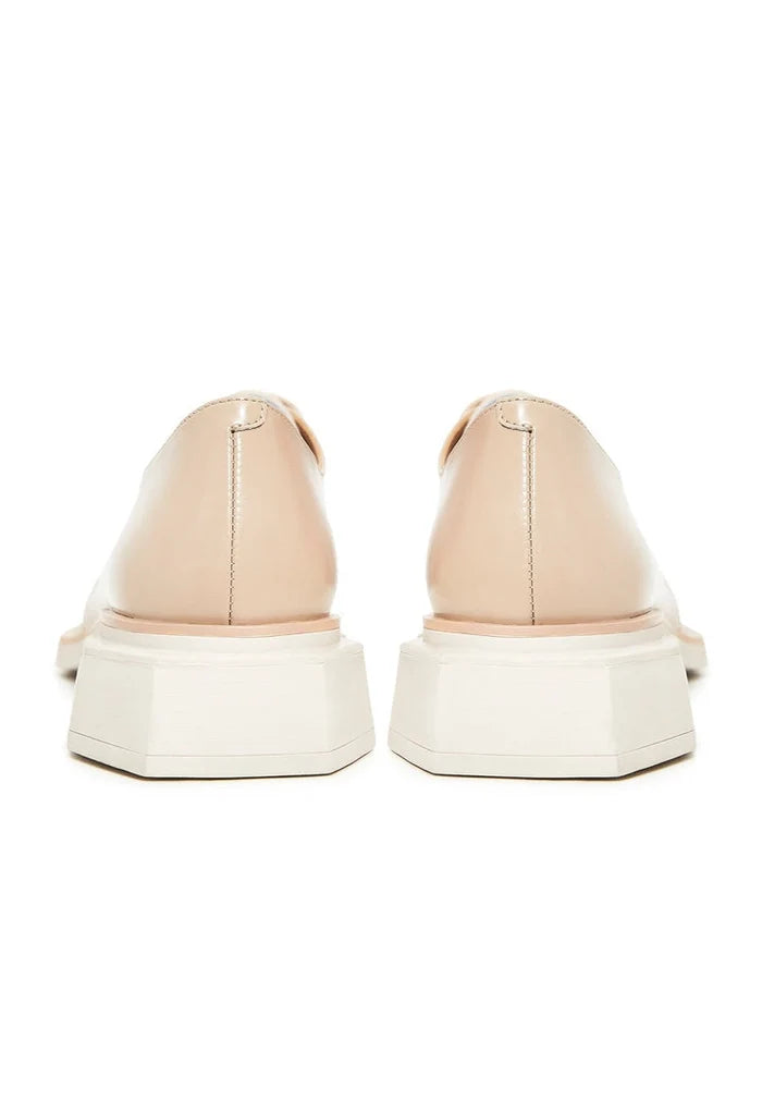 A stylish pair of beige leather lace-up loafers for men.