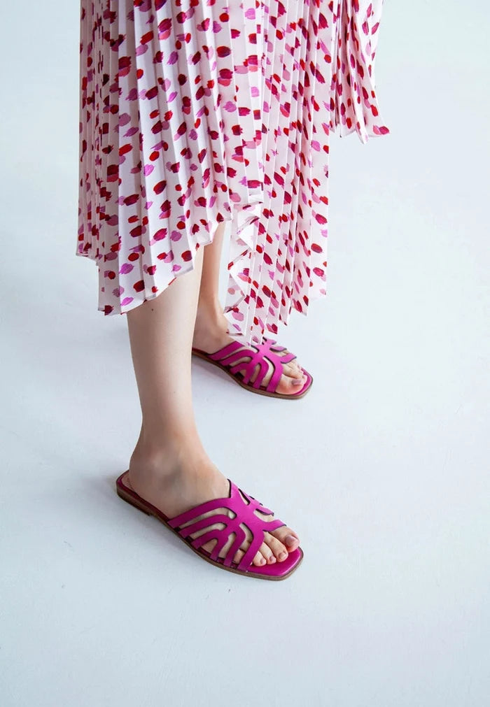 A pair of stylish pink laser cut sandals for women.