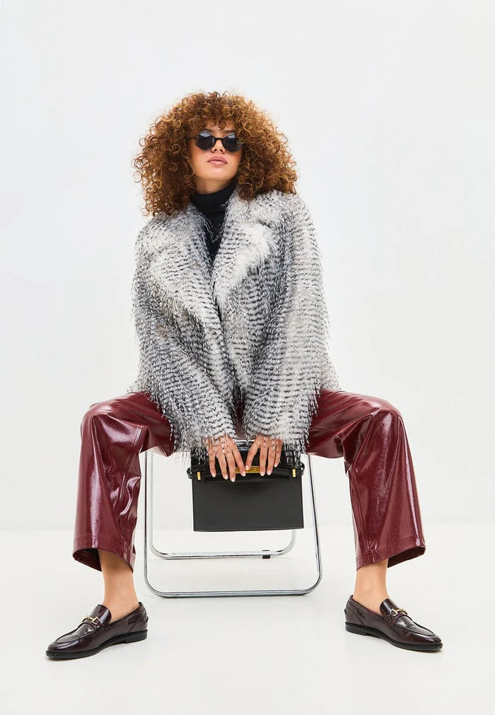 A stylish grey faux fur Monica coat, a lavish and short winter essential.
