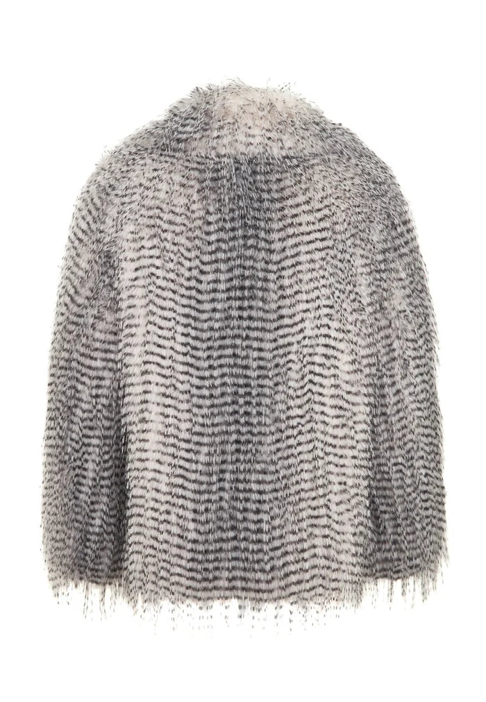 A luxurious short grey faux fur coat, the Monica coat - a lavish fashion statement.