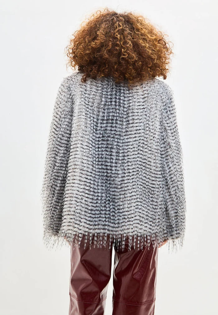 A stylish short grey faux fur coat, the Monica coat, perfect for any lavish outfit.