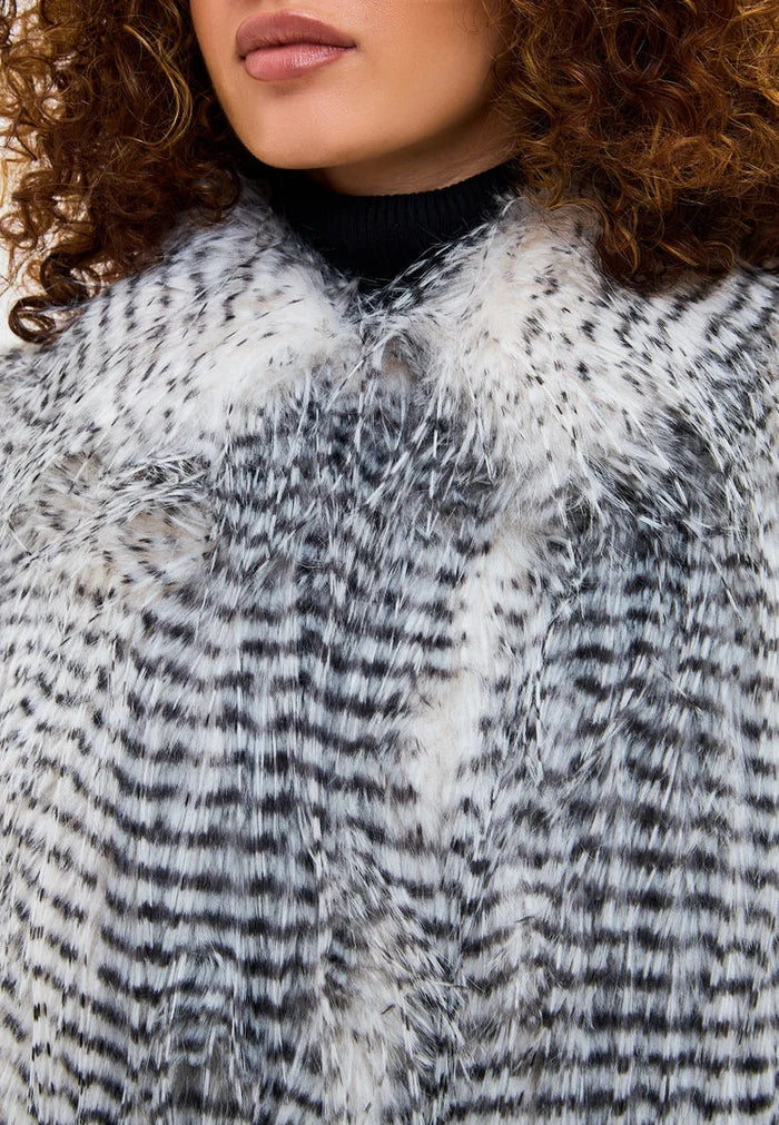 A stylish grey Monica faux fur coat, a lavish and short option for trendy fashionistas.