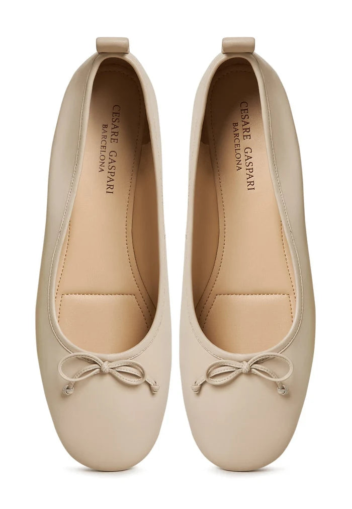 A pair of elegant ivory leather ballerinas - women's leather flats that are perfect as ivory ballet flats, leather slip-on shoes, or ivory dress shoes.