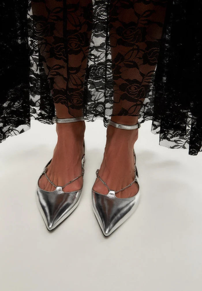 A stylish pair of silver leather ballerinas, also known as Clara ballet flats, perfect for any woman looking for fashionable and comfortable silver flat shoes.