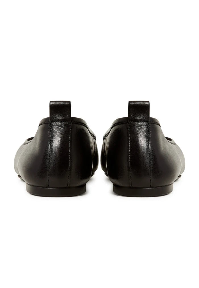 A close-up image of stylish black patent leather ballerinas, the Mila ballerinas, perfect for women looking for comfortable and chic black patent flats.